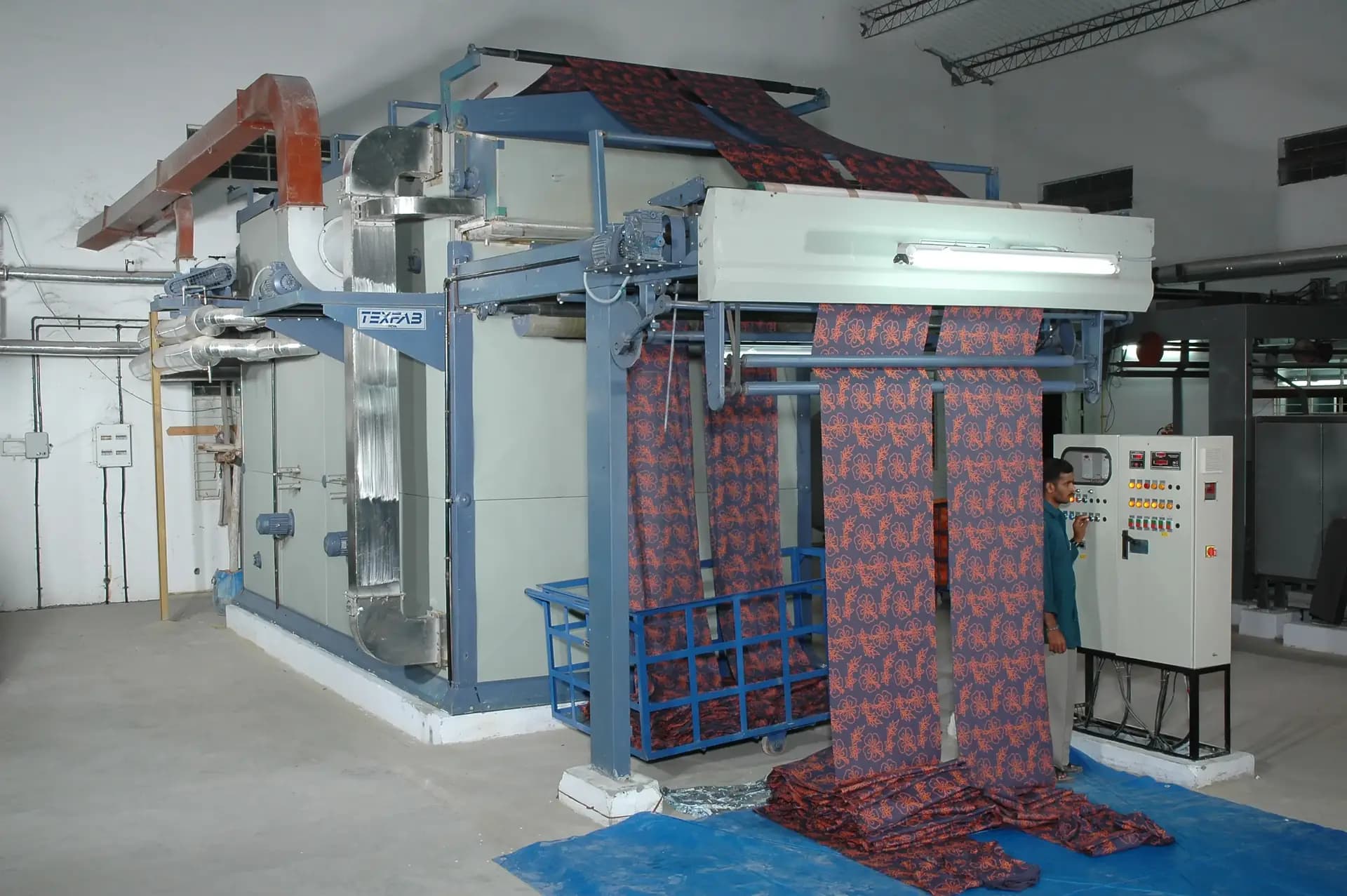 Printed fabric running through the dyeing line